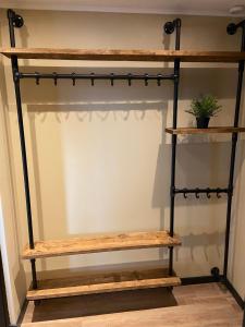 a shelf made out of reclaimed wood and black pipe at Apartment Malisa in Zandvoort