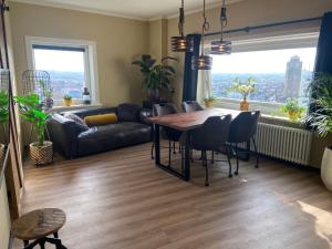 a living room with a table and chairs and a couch at Apartment Malisa in Zandvoort