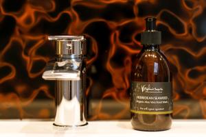 a bottle of oil next to a soap dispenser at Ceol na Mara Guest House in Tarbert