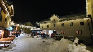 a snow covered street in a town at night at Apartments Seventy Seven in Kranjska Gora +116 photos