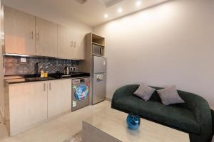 uma sala de estar com um sofá verde numa cozinha em شقق أحلى الأيام للوحدات السكنية المفروشة em Muhayil
