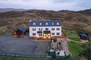 a large white house on top of a hill at Ceol na Mara Guest House in Tarbert