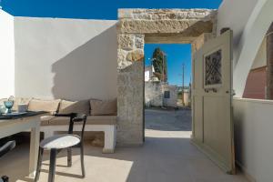 Habitación con sofá, mesa y puerta en Stonehouse South Crete, en Vóroi