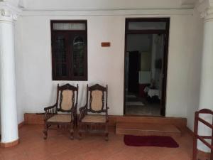 
two chairs and a table in a room at Lavila beach resort in Wadduwa
