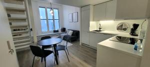 a kitchen and dining room with a table and chairs at Valjastehdas in Oulu