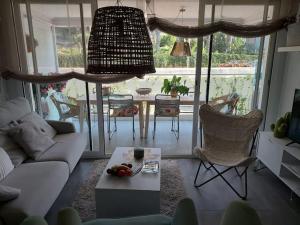 a living room with a couch and a table at Chic Home with garage Almuñecar San Cristobal in Almuñécar