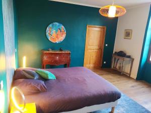 a bedroom with a bed and a green wall at Chateau de Beaucouse in Thoard