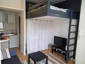 a living room with a bunk bed in a room at Studio avec terrasse en résidence calme à Dijon. in Dijon