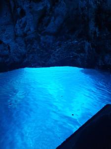 a pool of blue water in a cave at Apartments Tare, Electric Car Refill in Vodice