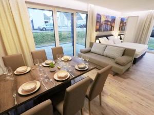 a dining room with a table and a couch at -Neubau- 68 qm 2-Zimmer-Wohnung in Fulda