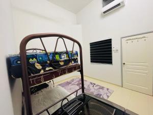 a bunk bed in a room with a bunk bed at HOMESTAY PD in Port Dickson