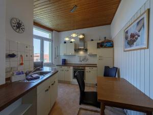 a kitchen with a sink and a table and a counter at Oase am See in Waren