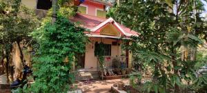 a small house surrounded by trees and plants at Cheerful Villa at Chaul Alibag Near Revdanda and Nagav Beach in Alibaug