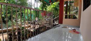 a balcony with a fence with plants at Cheerful Villa at Chaul Alibag Near Revdanda and Nagav Beach in Alibaug +5 photos