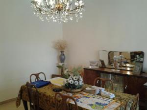 a dining room with a table and a chandelier at B&BGalatina1 CIS in Galatina +25 photos