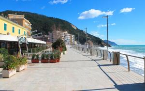 a sidewalk next to a beach with plants and the ocean at Leo Holiday Homes in Deiva Marina
