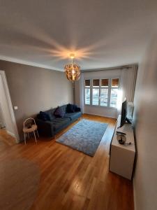 a living room with a couch and a table at Bel appartement 2 pièces, sortie de métro ligne 8 in Charenton-le-Pont