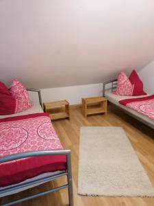 a room with two beds and a rug at Ferienwohnung Yara Rödental in Rödental
