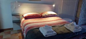 a bedroom with a bed with towels on it at Via Roma 81 in San Giovanni in Galdo