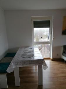 a white table in a room with a window at Ferienwohnung Yara Rödental in Rödental