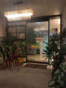 a store front with plants and a chandelier at Boston Plus Hotel in Chiayi City