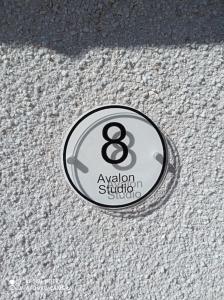 a metal button on a white carpeted floor at Avalon Studio. Comfy well equipped cosy studio. in Aviemore