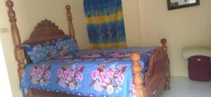 a bedroom with a bed with a rainbow curtain at Lovely 1-Bed Cottage in St catherine Jamaica in Ewarton