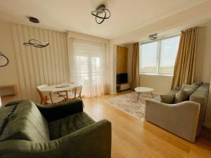 a living room with two couches and a table at Belvedere Apartments in Ulcinj