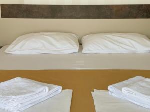 a bunk bed with white pillows and towels on it at Belvedere Apartments in Ulcinj