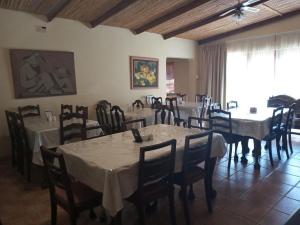 a dining room with tables and chairs and a large window at Route 62 B&B in Robertson