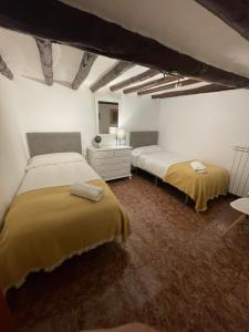 a bedroom with two beds in a room at Casa Grasa in Radiquero