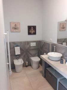 a bathroom with two sinks and two toilets at La Cittadella10 in Turin