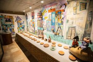 a display of wooden bowls on a table in a museum at History of Tbilisi in Tbilisi City