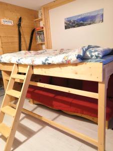 a bunk bed in a room with a desk at Résidence "Rado" in Samoëns