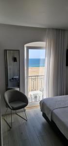 
a hotel room with a bed and a window at Hotel Mar Bravo in Nazaré
