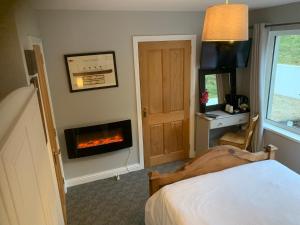 a bedroom with a fireplace in the corner of a room at The View at 37 B&B in Banbridge