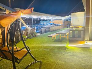 a patio with a table and a bench and an umbrella at 東澳海安獨木舟背包客棧Hai An 2 Hostel in Suao