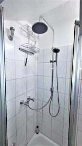 a bathroom with a shower with a shower head at Golden Treasure Superior in Münster