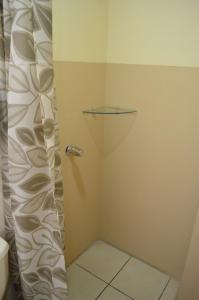 a shower with a glass door in a bathroom at #3 Private room Close to Airport in Alajuela