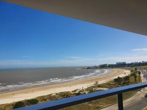 a view of the beach from a balcony at Modern apartment first line beach Montevideo UY in Montevideo