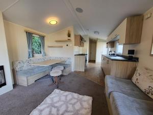 a living room with a couch and a table at Caravan Kensington 46 at Marton Mere Blackpool in Blackpool