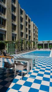 a patio with a table and chairs and a pool at LivinnX Barranquilla in Barranquilla