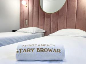 poduszka do przeglądania apartmenteryarityarityarityarityarity na łóżku w obiekcie Apartamenty Stary Browar Oleśnica w mieście Oleśnica