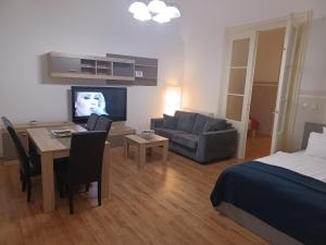 a living room with a bed and a room with a dining table at Apartment George&Dragon in Zagreb