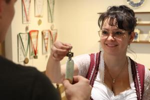 a woman is holding a pair of scissors at Hotel Waldhäusel in Bad Schandau