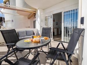 a table with a plate of food on a balcony at Apartment on Beach Mijas in Mijas Costa
