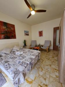 a bedroom with a bed and a ceiling fan at Casa dell amore 1 in Sanremo