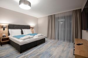 Postel nebo postele na pokoji v ubytování Hotel Jarzębata