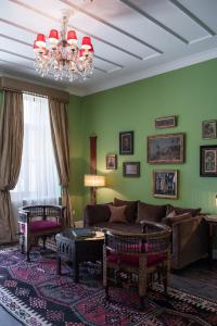 a living room with a couch and a chandelier at La Maison Ottomane in Chania