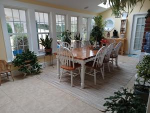 a dining room with a wooden table and chairs at The Inn on Bath Creek in Bath